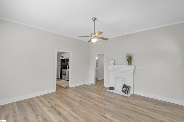 unfurnished living room featuring ornamental molding, light wood-type flooring, and baseboards