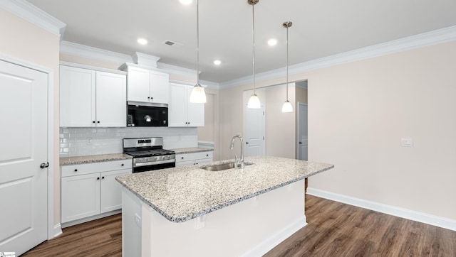 kitchen featuring stainless steel gas stove, white cabinets, an island with sink, pendant lighting, and a sink