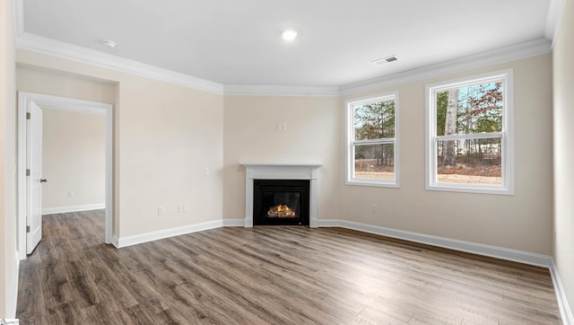 unfurnished living room featuring visible vents, baseboards, a glass covered fireplace, dark wood-style floors, and ornamental molding