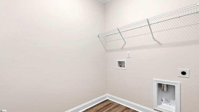 laundry room featuring hookup for a washing machine, hookup for an electric dryer, laundry area, wood finished floors, and baseboards