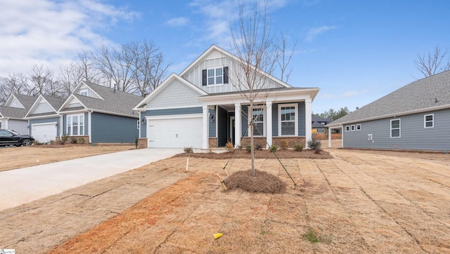 craftsman inspired home with a garage, concrete driveway, brick siding, and board and batten siding