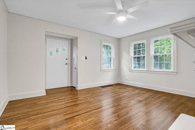 unfurnished room with hardwood / wood-style flooring and ceiling fan