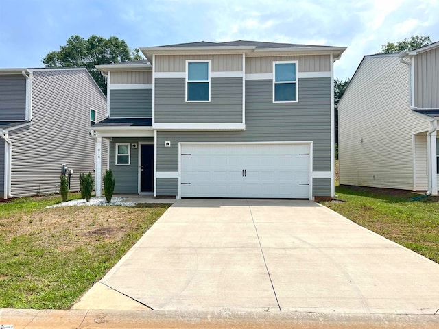 view of front of property with a garage and a front yard