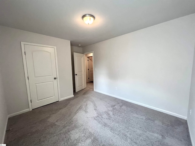 unfurnished bedroom with carpet flooring and a closet