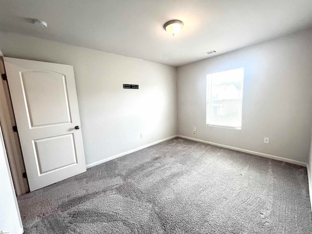 unfurnished room featuring carpet