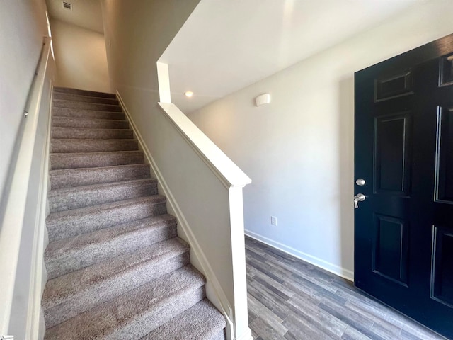 stairs with hardwood / wood-style flooring