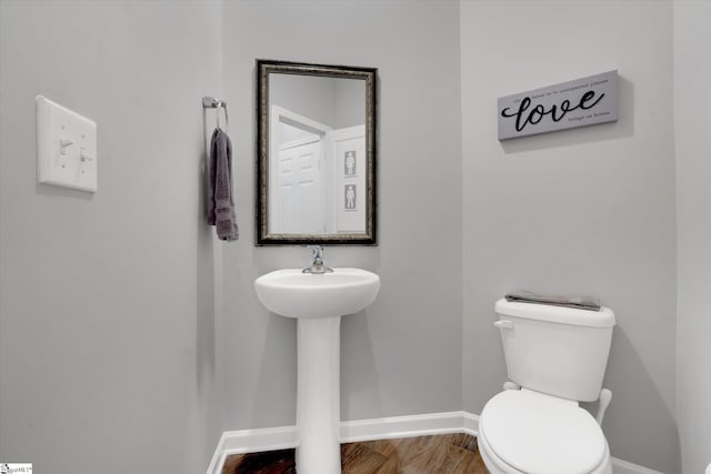 bathroom featuring hardwood / wood-style floors and toilet