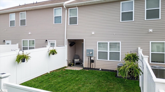 rear view of house featuring a lawn