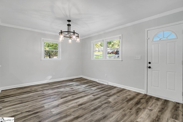 foyer entrance featuring a chandelier, dark wood-type flooring, and ornamental molding