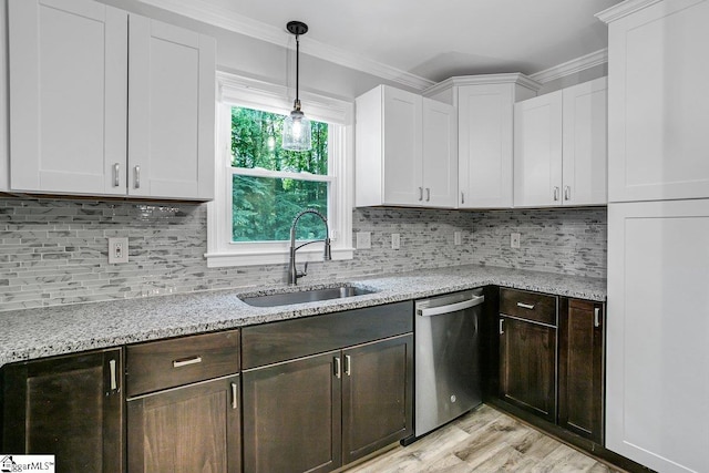 kitchen featuring decorative backsplash, sink, white cabinets, and dishwasher