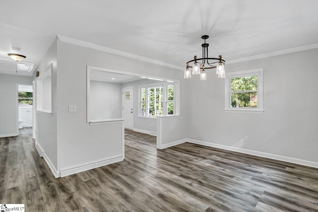 spare room featuring dark hardwood / wood-style flooring, ornamental molding, and plenty of natural light