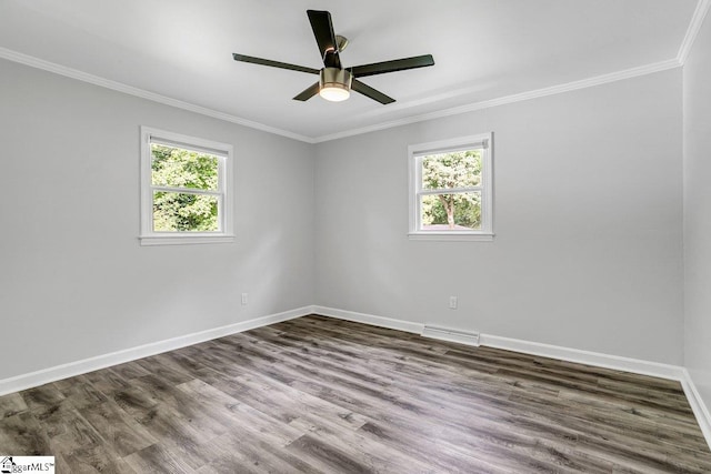 empty room featuring wood-type flooring, ornamental molding, and a healthy amount of sunlight