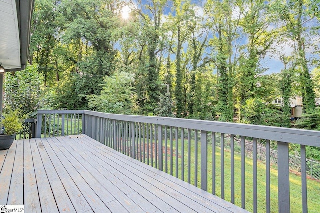 wooden terrace with a lawn