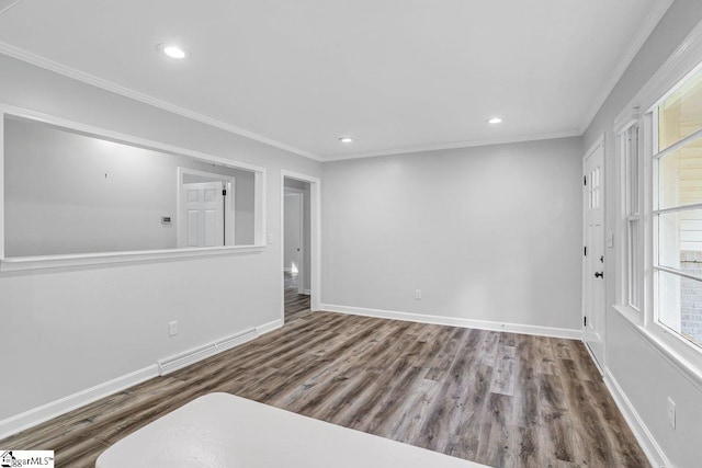 empty room featuring wood-type flooring and crown molding