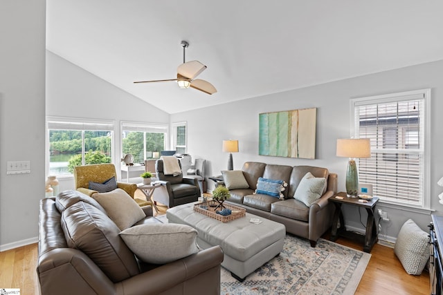 living room featuring vaulted ceiling, ceiling fan, and light hardwood / wood-style floors