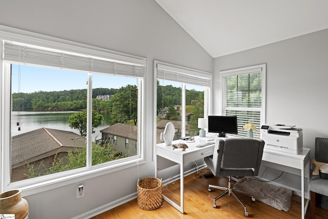 office area with a water view, vaulted ceiling, and hardwood / wood-style flooring