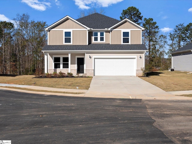 craftsman house with a garage and a front lawn