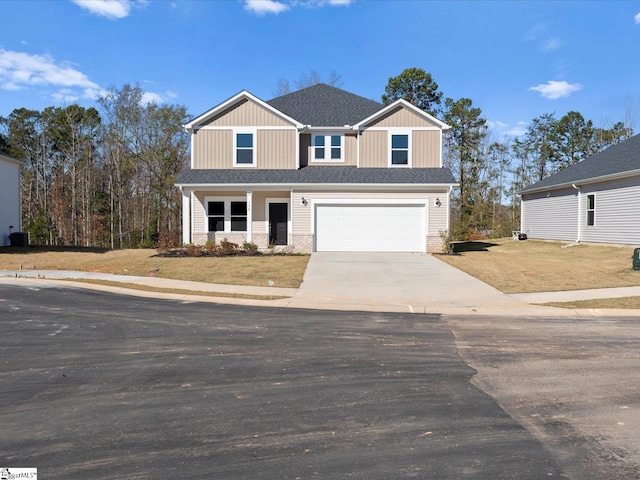 view of front of house with a garage and a front lawn