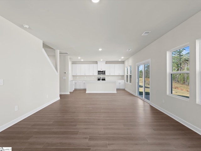 unfurnished living room with dark hardwood / wood-style flooring