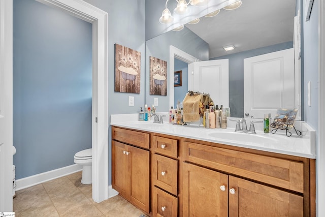 bathroom featuring vanity, tile patterned floors, and toilet