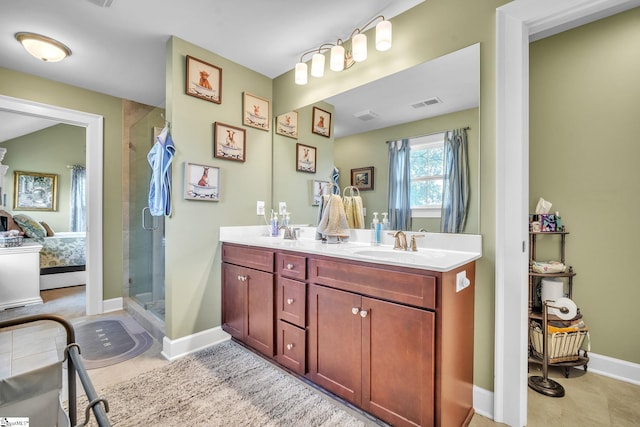 bathroom with vanity, a shower with shower door, and tile patterned floors