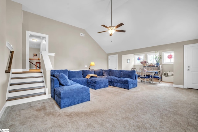 carpeted living room with high vaulted ceiling and ceiling fan