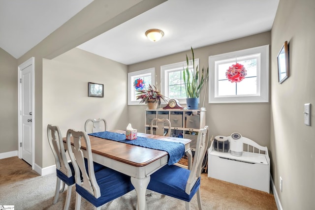 dining room with light colored carpet