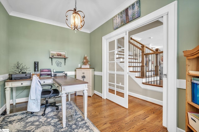 office area with an inviting chandelier, ornamental molding, and wood-type flooring