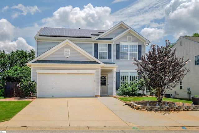 view of front of property featuring solar panels and a garage