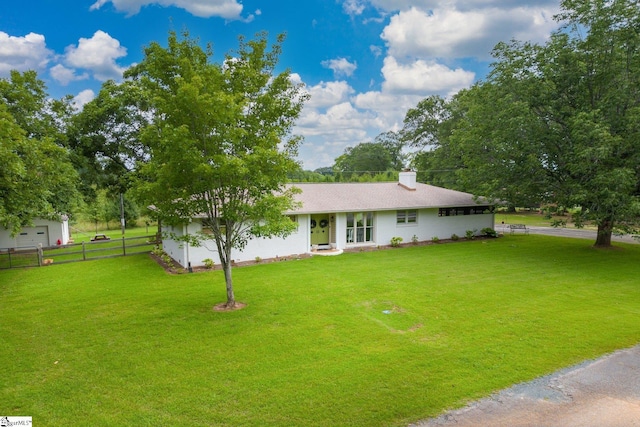 single story home featuring a garage and a front yard