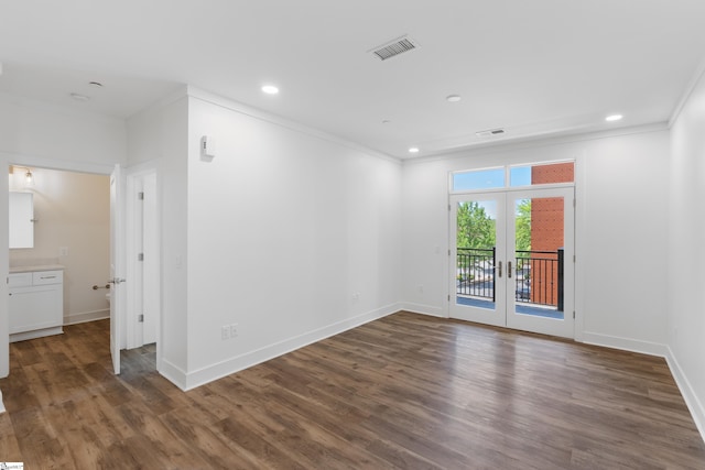 spare room featuring french doors, hardwood / wood-style flooring, and ornamental molding