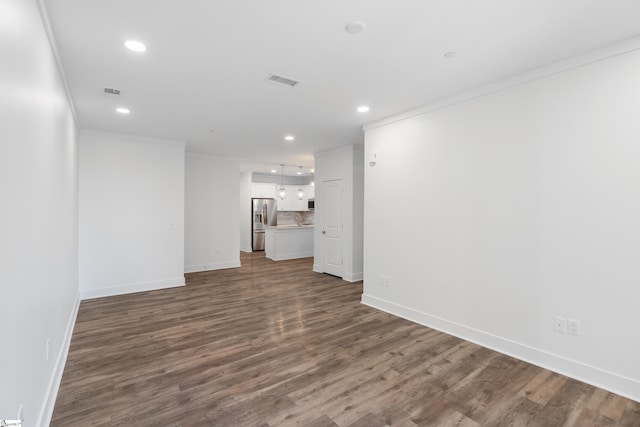 unfurnished living room featuring hardwood / wood-style flooring and crown molding