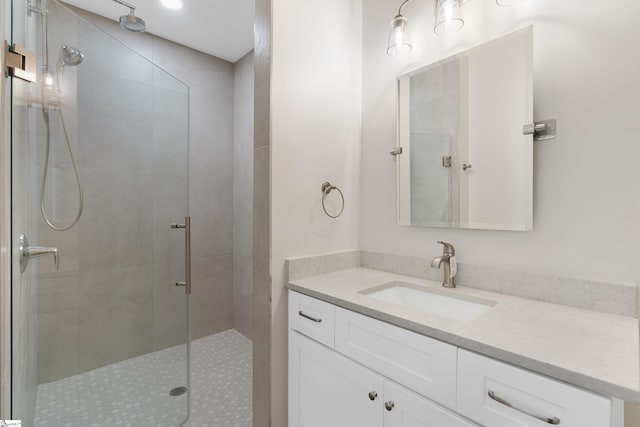 bathroom featuring vanity and a tile shower