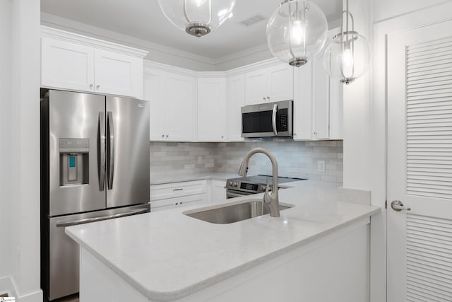 kitchen with stainless steel appliances, light stone counters, hanging light fixtures, backsplash, and white cabinetry