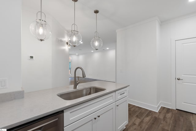 kitchen featuring sink, decorative light fixtures, stainless steel dishwasher, white cabinetry, and dark wood-type flooring