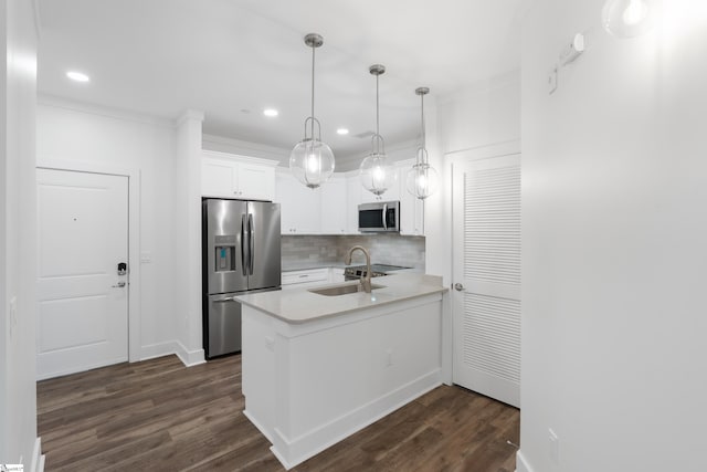 kitchen with decorative backsplash, appliances with stainless steel finishes, dark hardwood / wood-style flooring, and white cabinetry