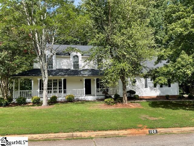 view of front facade with a porch and a front lawn