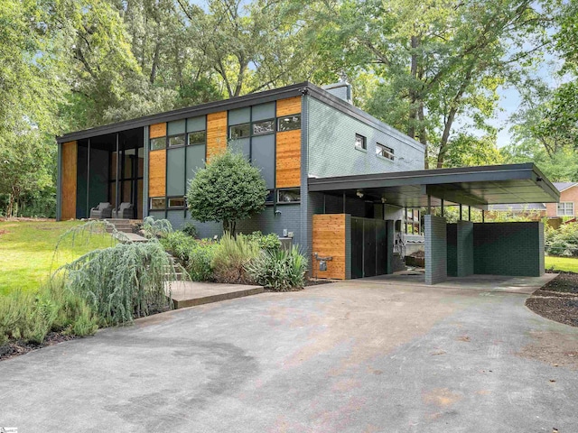 contemporary home with a carport and concrete driveway