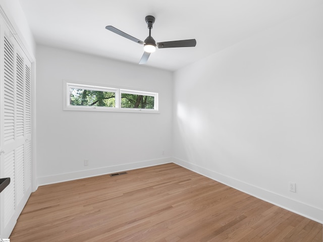 unfurnished bedroom with light wood finished floors, visible vents, baseboards, a ceiling fan, and a closet