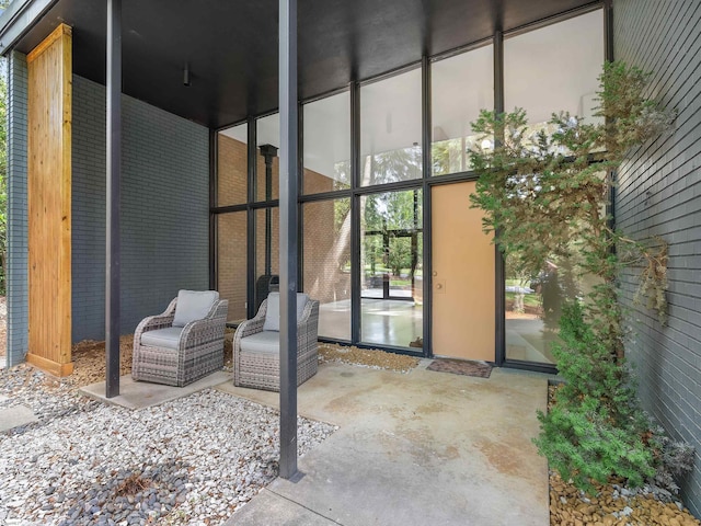 property entrance featuring brick siding and a patio area