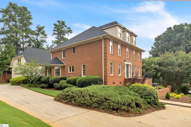 view of home's exterior featuring brick siding and crawl space