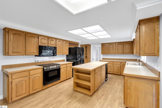 kitchen with open shelves, black appliances, light wood-type flooring, and a sink