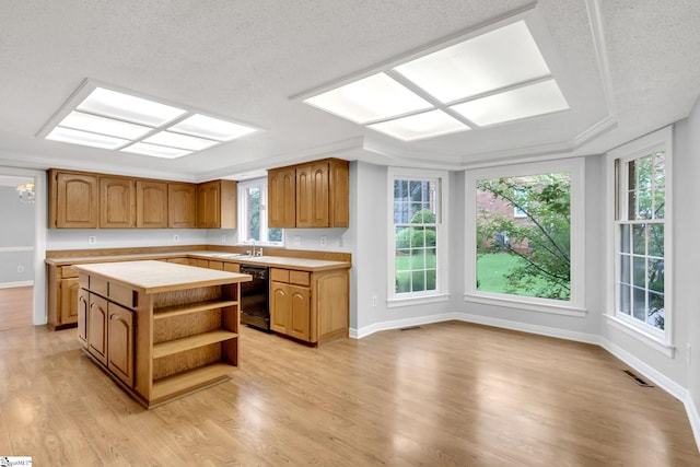 kitchen featuring visible vents, a kitchen island, light wood-type flooring, black dishwasher, and open shelves