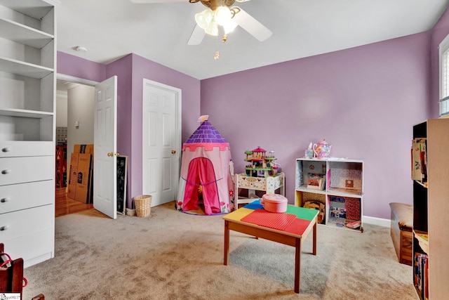 rec room featuring light carpet and ceiling fan