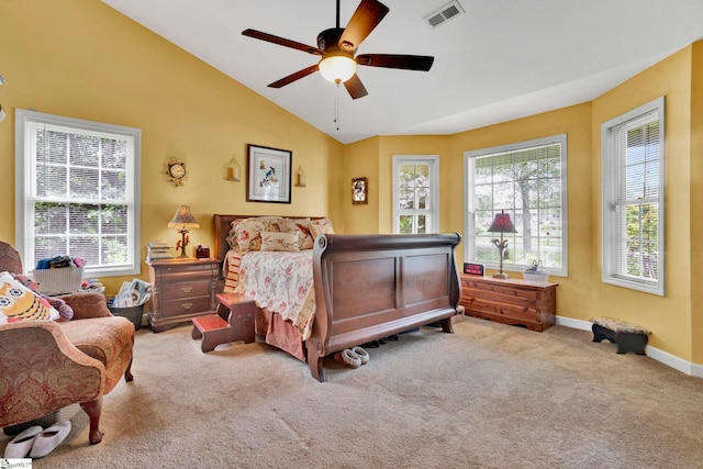 carpeted bedroom featuring multiple windows, lofted ceiling, and ceiling fan