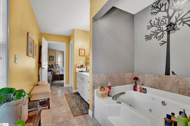 bathroom with tile patterned floors, a bathing tub, and vanity