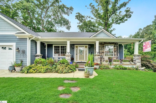 view of front of home with a porch, a garage, and a front lawn