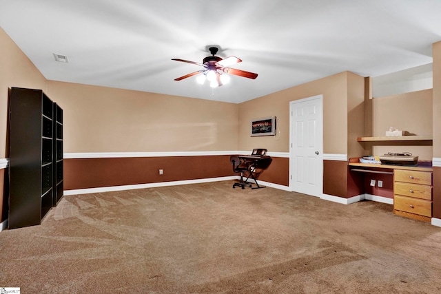 home office featuring dark colored carpet and ceiling fan