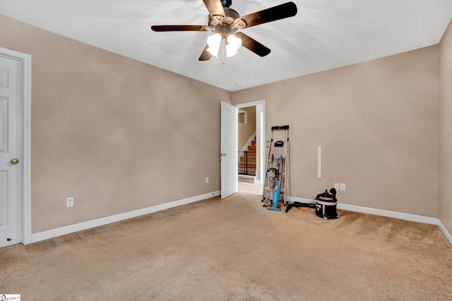 miscellaneous room featuring ceiling fan and light colored carpet