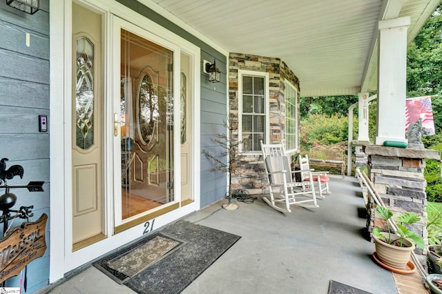 view of exterior entry with covered porch